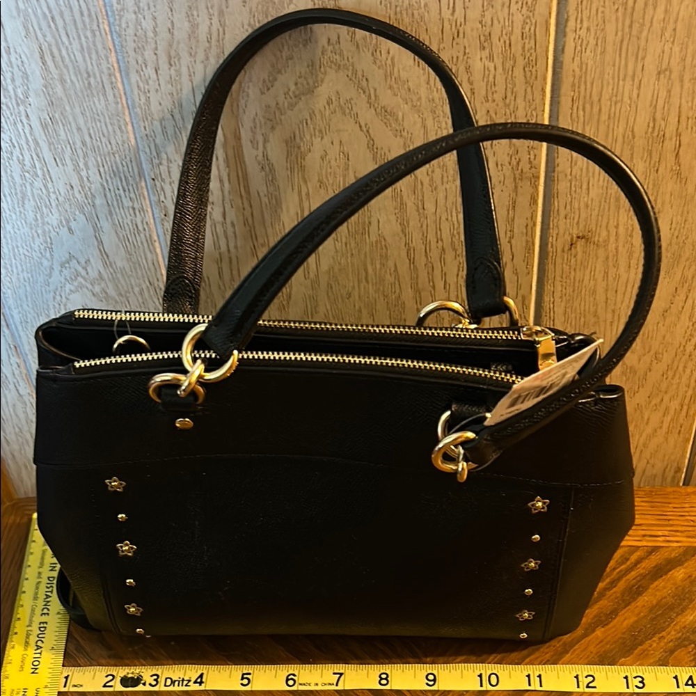 Elegant Coach, Black Handbag with Gold Accents, also has crossbody strap